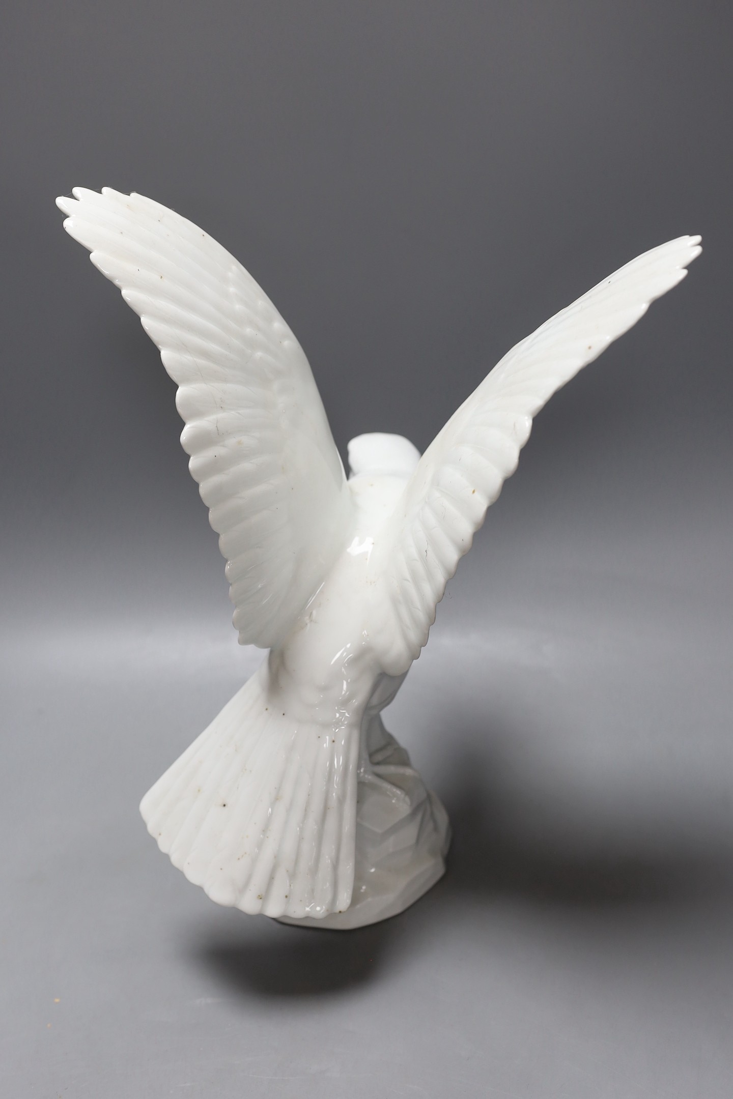 A modern Dresden porcelain model of a perching falcon, 37cms high.